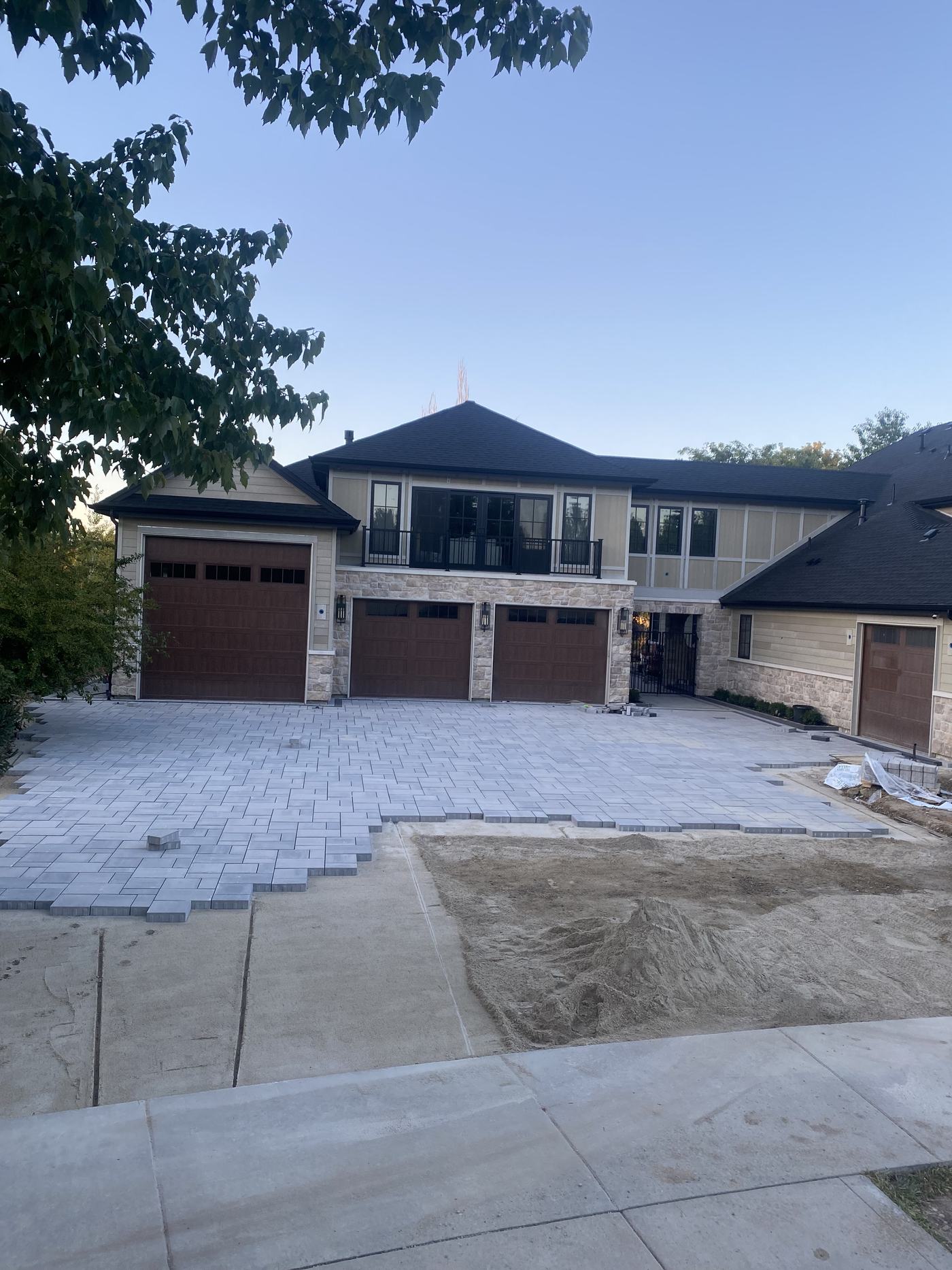 The same driveway from the street, part-laid, with bare ground still showing on one side.